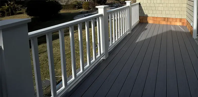 Wooden deck painted gray on top of a story home.